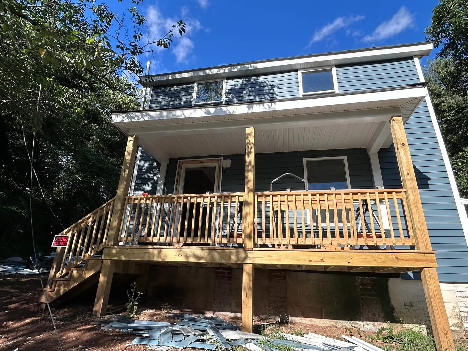 Garfield Avenue exterior renovation in progress with new siding and porch framing