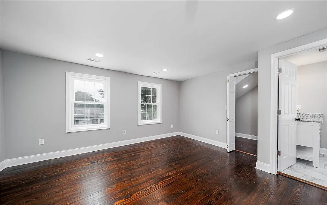 Completed Lynchburg Avenue bedroom with restored hardwood floors