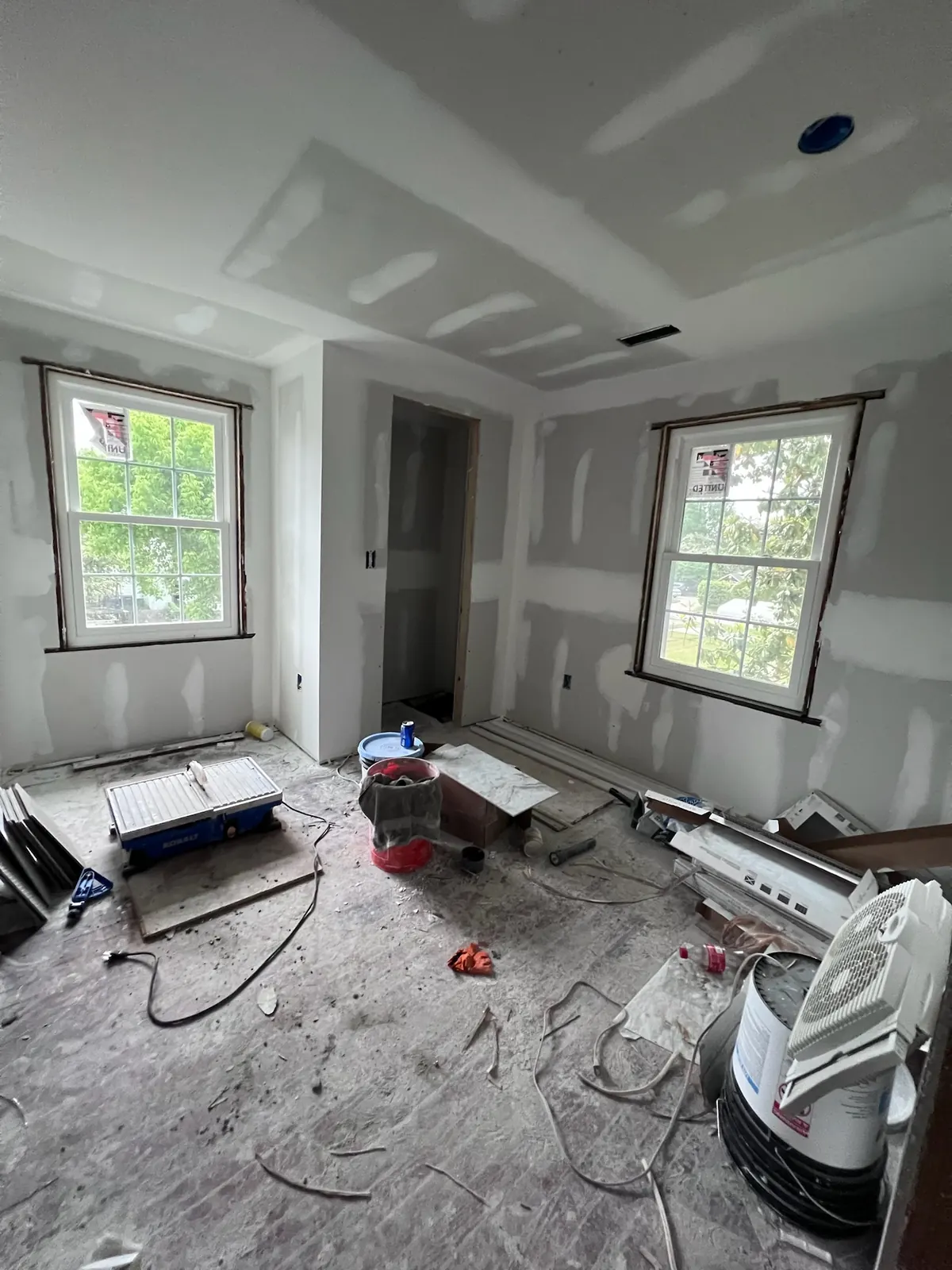 Bedroom during drywall installation and finishing