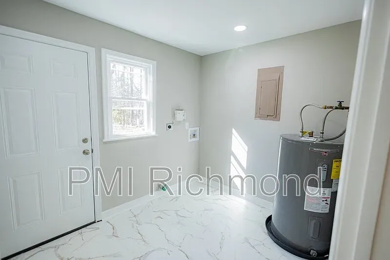 Completed Kingsland Rd utility room with water heater and updated electrical panel